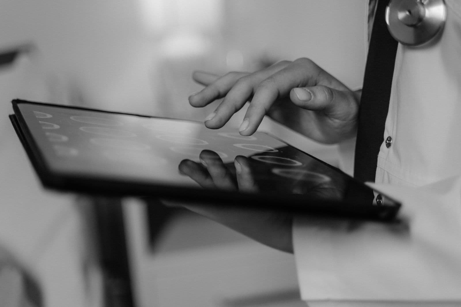 Clinician using a touchscreen tablet in a clinical setting