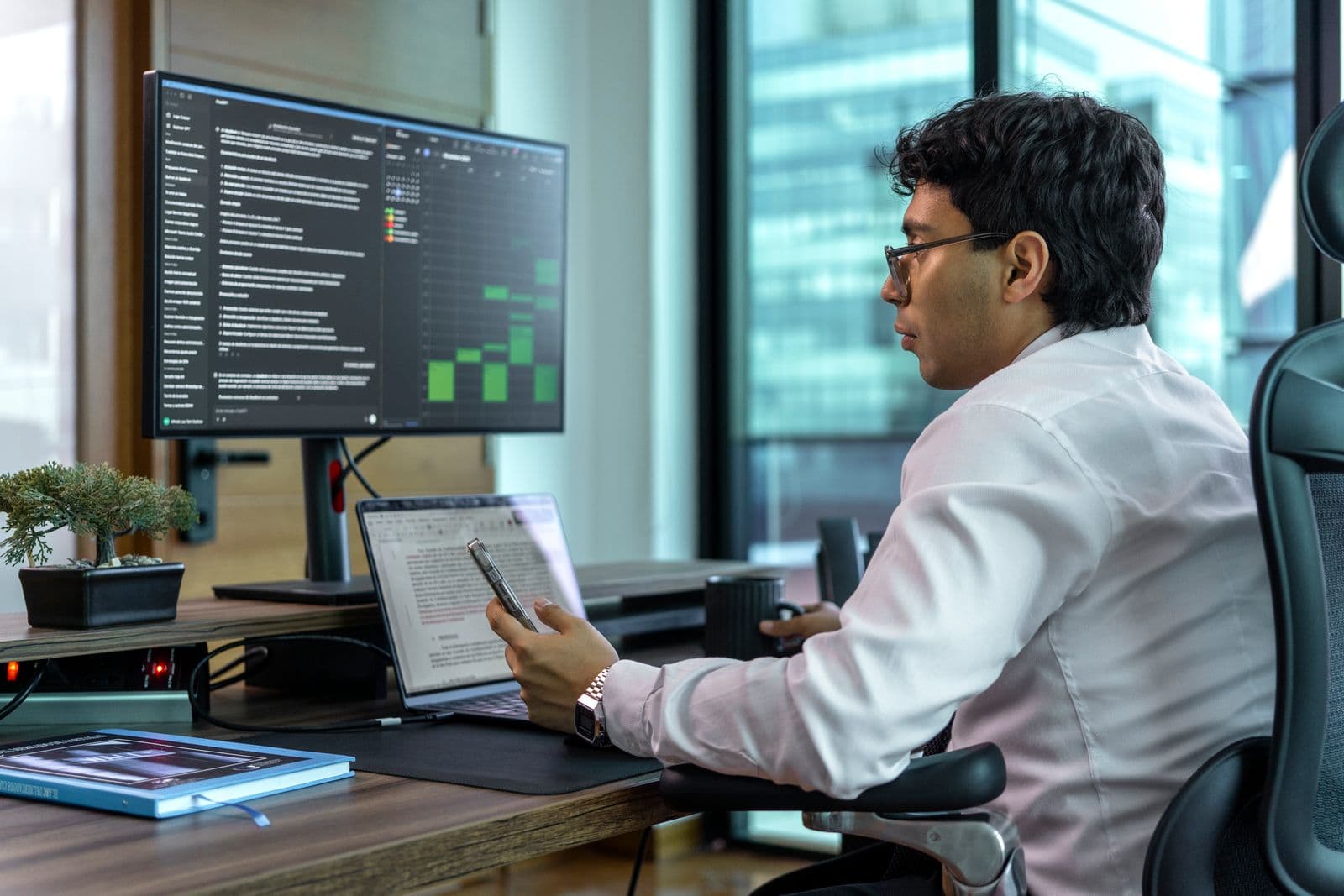 Data analyst working at a workstation with multiple data views