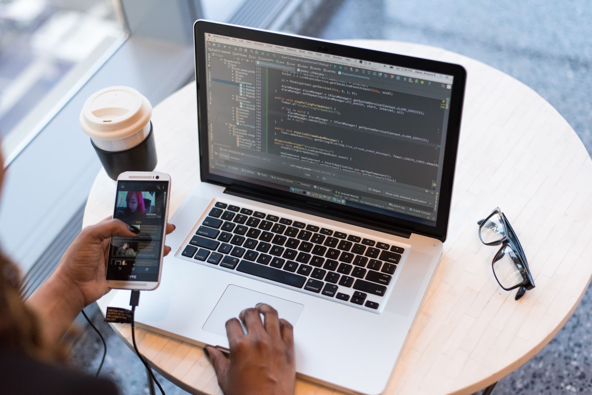 Developer testing a mobile app on a physical smartphone