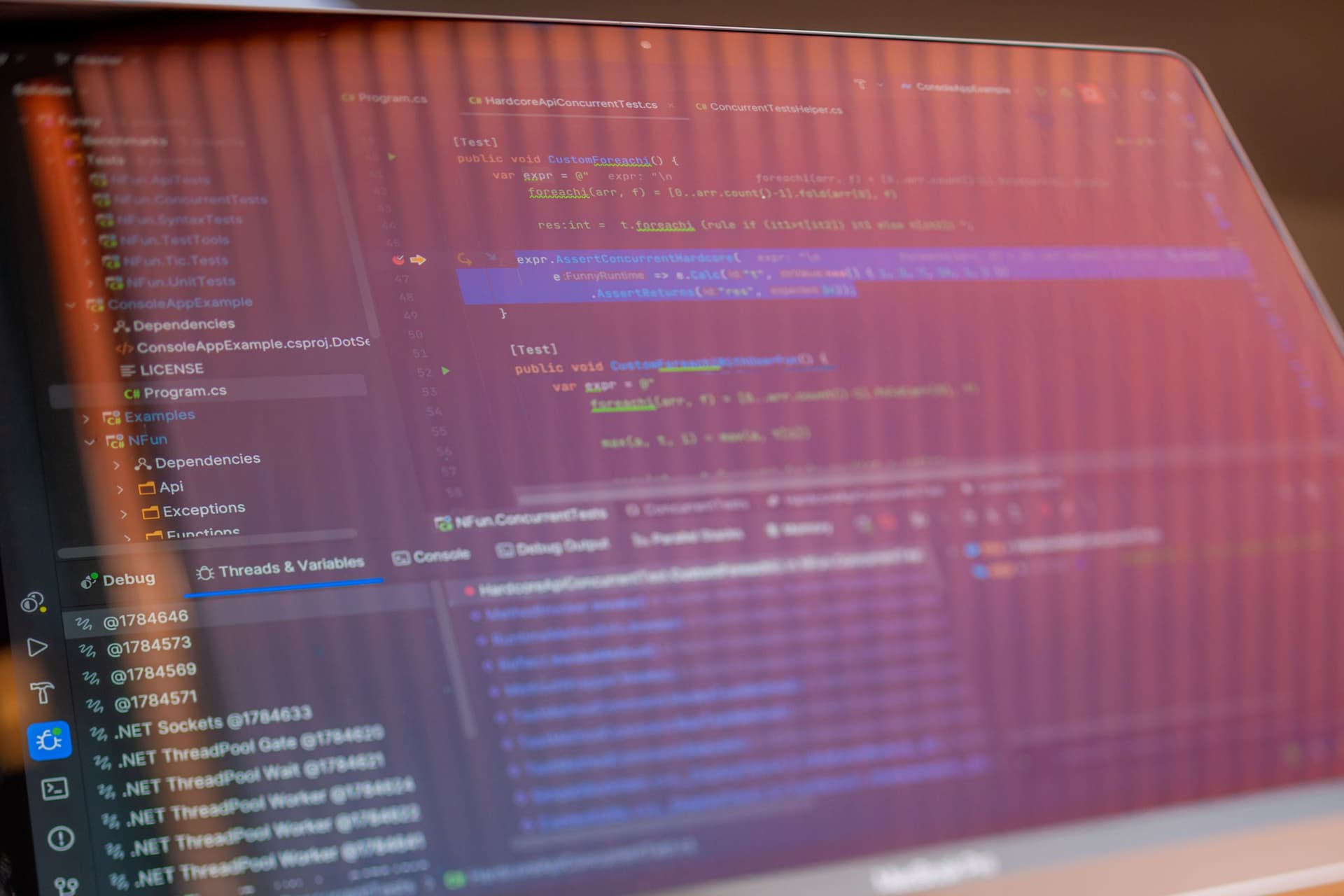 Code editor showing a test suite with assertions and a debugger panel