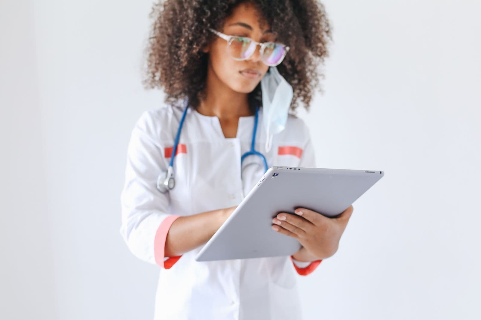 Doctor using a tablet in a clinical environment