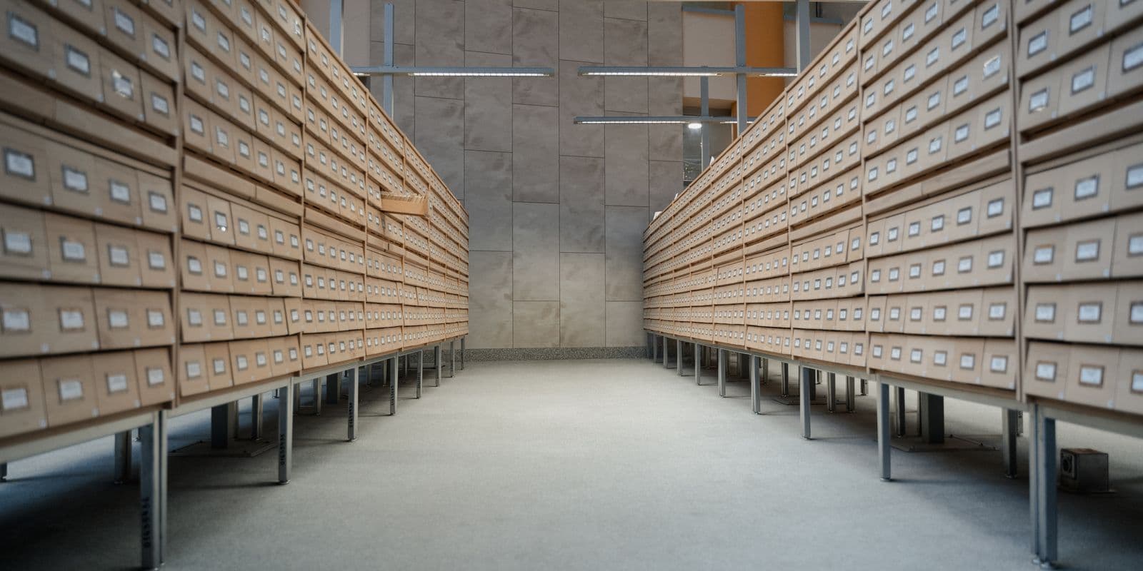 Archive hall lined with rows of indexed filing drawers